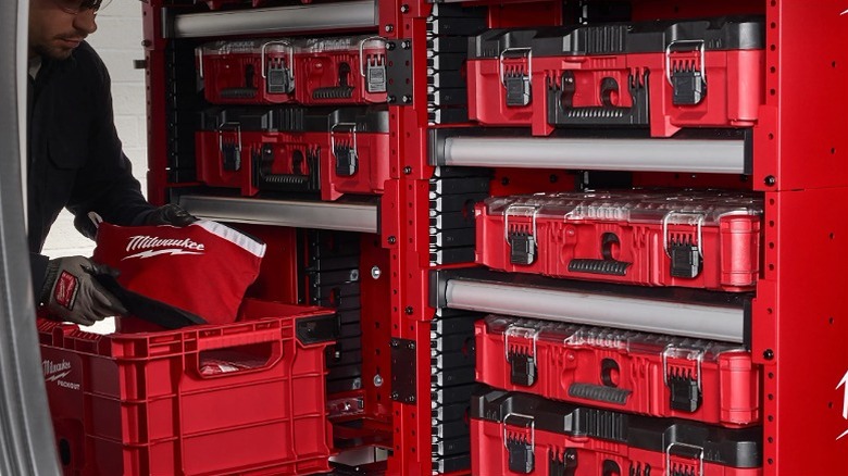 Several toolboxes stored in drawers of the rack.