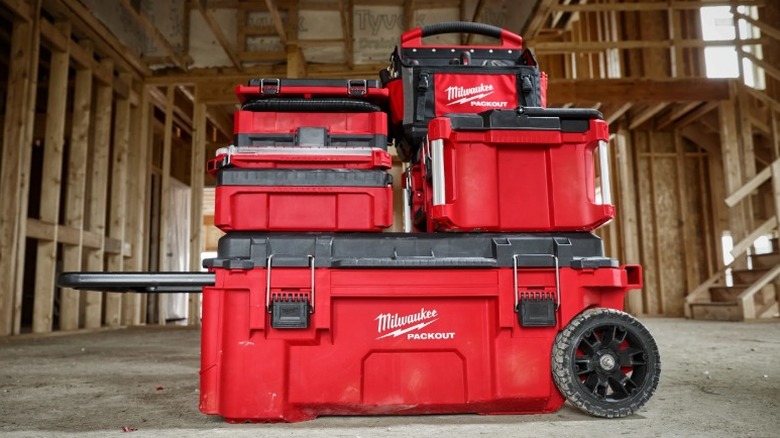 Toolboxes and bags stacked on top of a rolling tool chest.
