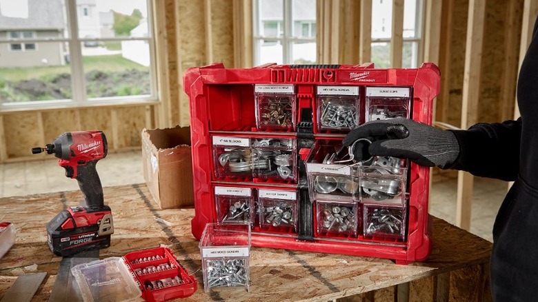 Tilt bin organizer with multiple small and large bins consisting of small accessories.