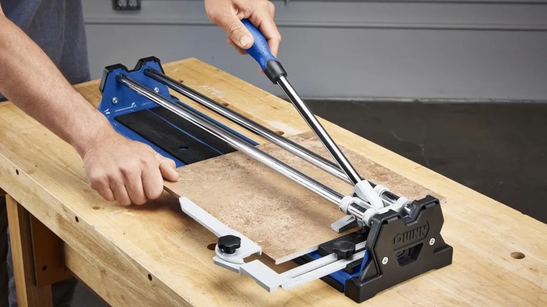 Person using Quinn Tools tile cutter