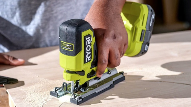 Person using a Ryobi jigsaw