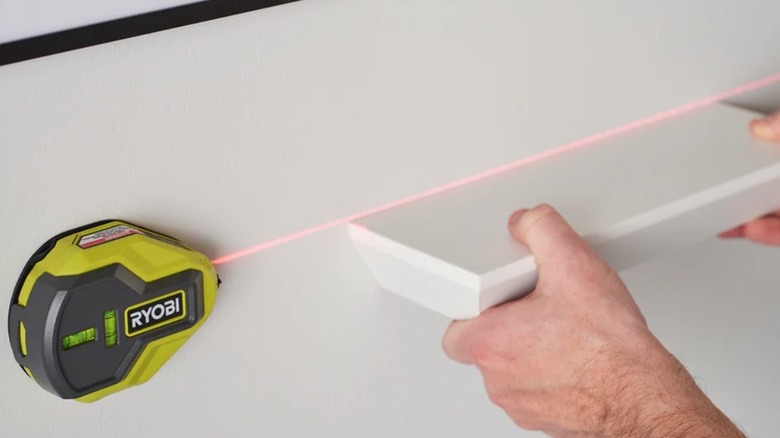 Person using a Ryobi laser level