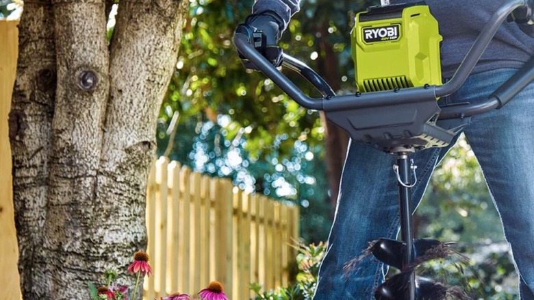 Person using a Ryobi auger