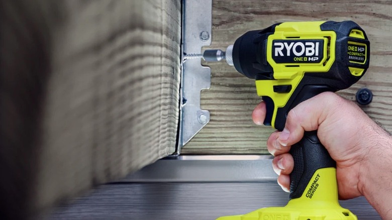Person using a Ryobi impact driver