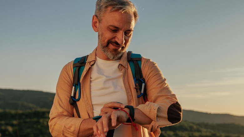 Hiker checking Apple Watch