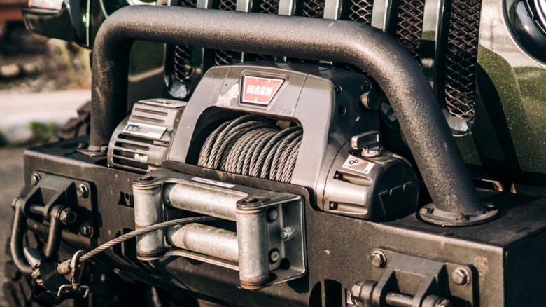 a winch installed on a heavy duty bumper on a Jeep Wrangler