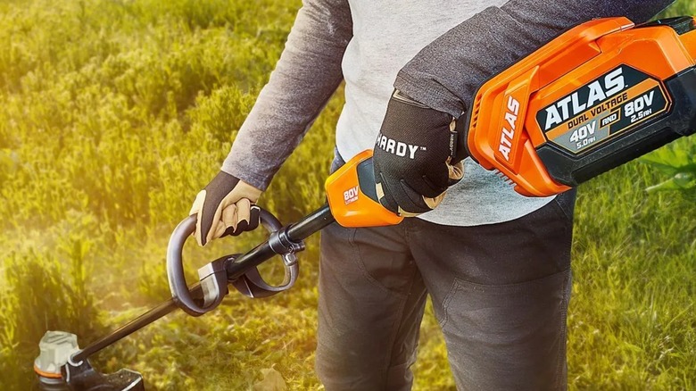 A person using the Atlas string trimmer from Harbor Freight.