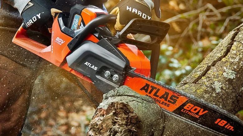 A person using an Atlas chainsaw from Harbor Freight.