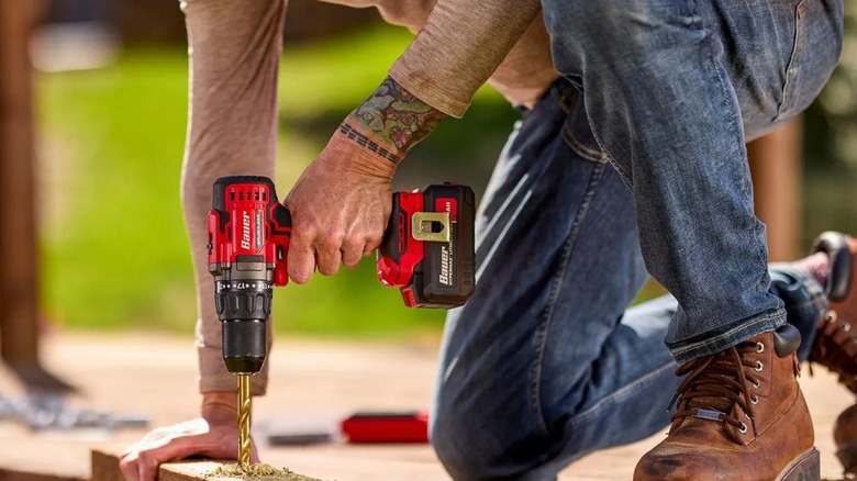 A person using a Bauer drill driver from Harbor Freight.