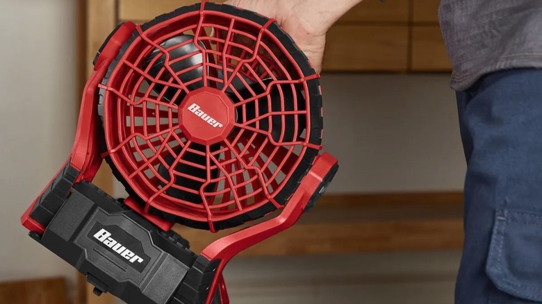 Person carrying Bauer dual power fan