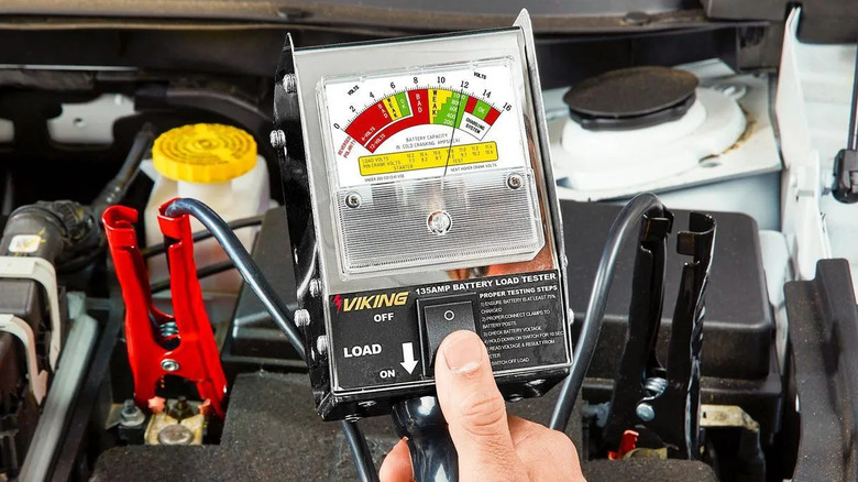 person holding battery tester