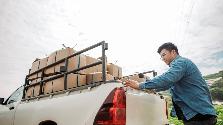 person loading boxes into pickup