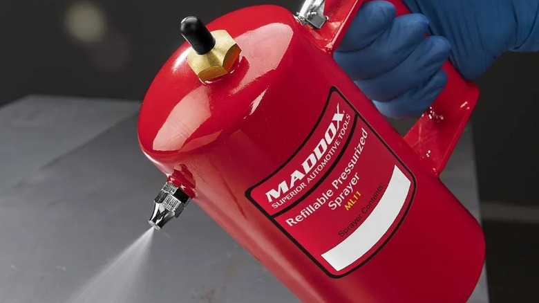 Person using a Maddox pressure sprayer