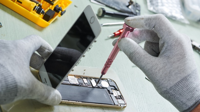 Person disassembling smartphone
