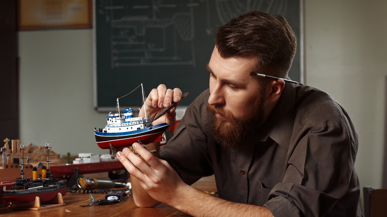 Man building model ship
