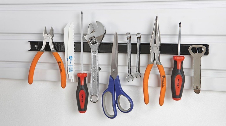 Wrenches, screwdrivers, and pliers are among the tools hanging on a U.S. General magnetic strip.
