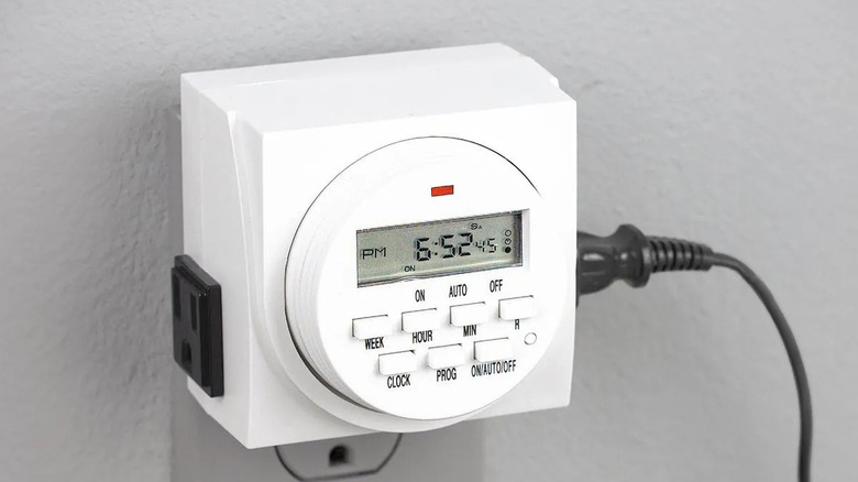 Chicago Electric's Digital Timer attached to a wall outlet, displaying the time as 6:52 PM