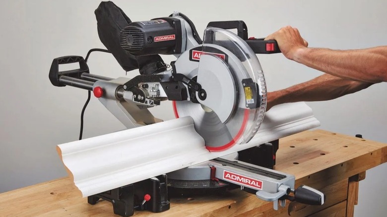 Person using Admiral Compound Miter Saw