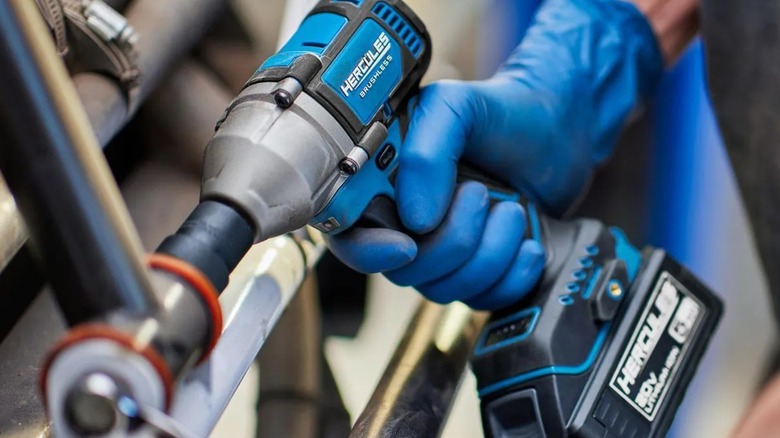A person using a Hercules impact driver on a bolt.