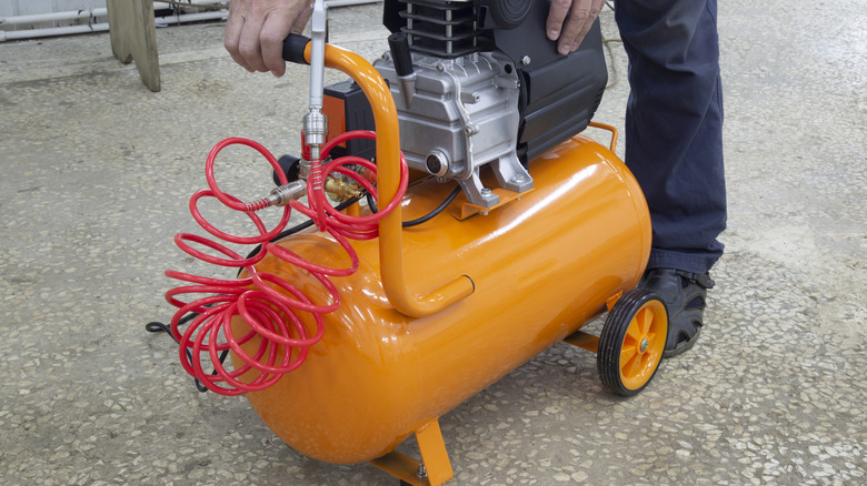 A person using an air compressor.
