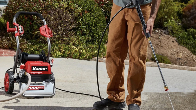 man using power tiles on concrete