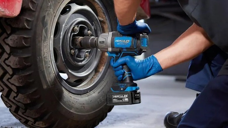 Person using Hercules 20V ½-inch Ultra Torque Impact Wrench on truck tire