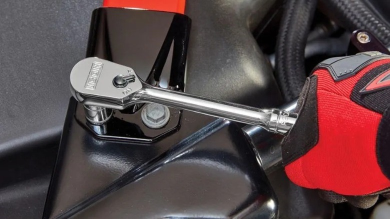 Person tightening framing bolt with an Icon ⅜-inch Drive Professional Low-Profile Ratchet