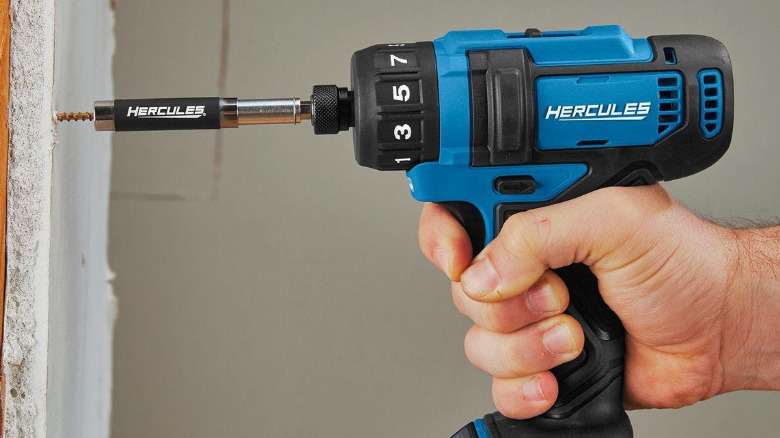 A person driving a screw into a wall with the Hercules 12V Cordless Screwdriver.