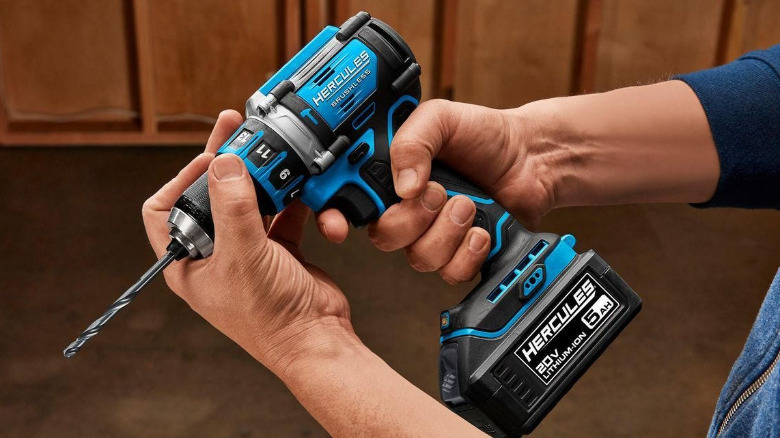 A person holding a Hercules 20V ½-inch Drill/Driver in hand.