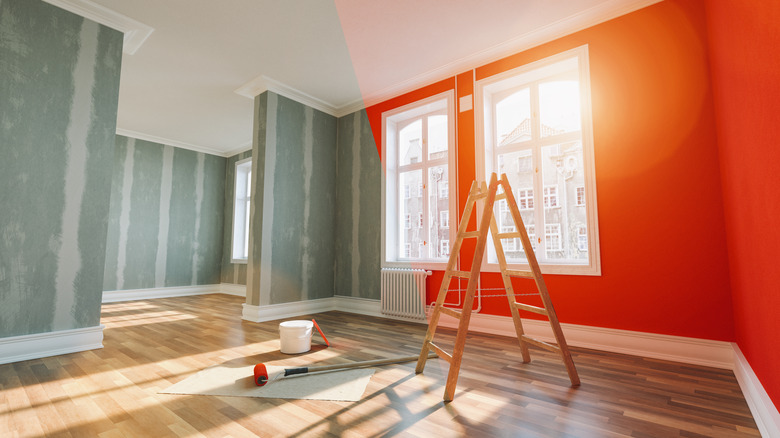 home restoration in progress with ladder and paint roller