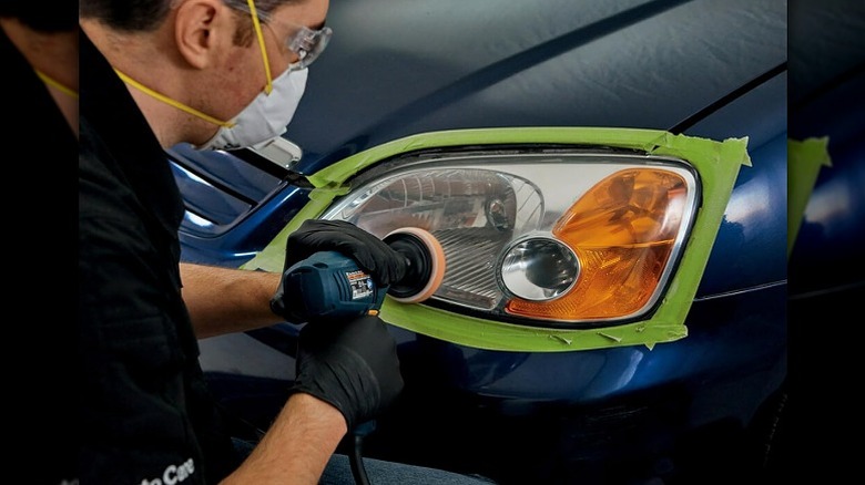 Man sanding a headlight
