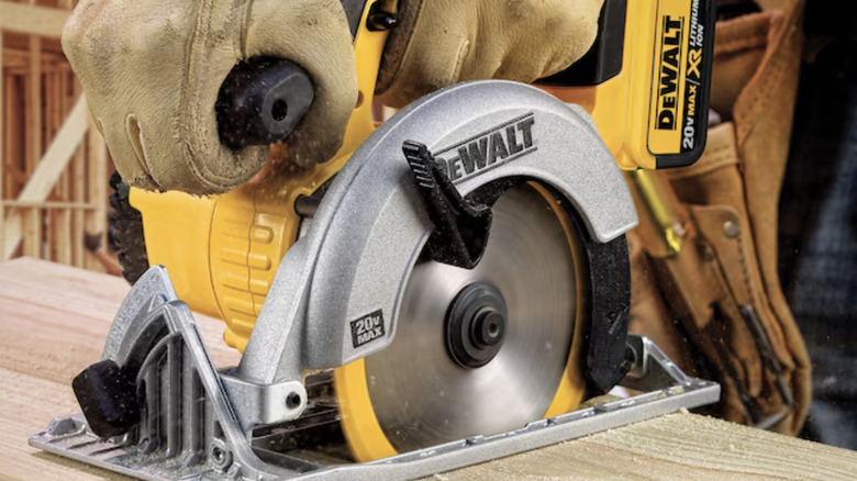man using circular saw on wood