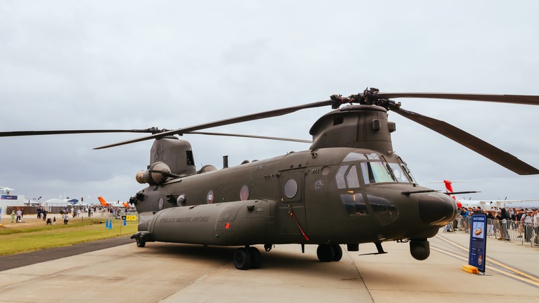 Boeing CH-47F Chinook parked at airport on taxiway during an airshow, front-starboard view