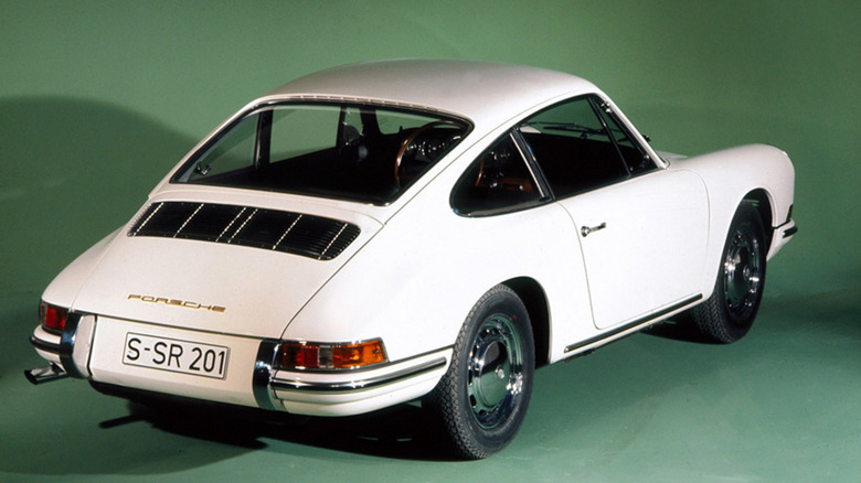 White 1965 Porsche 911 on green background