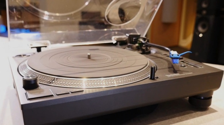 A Technics SL-1210GR2 turntable on a desk with the dustcover raised