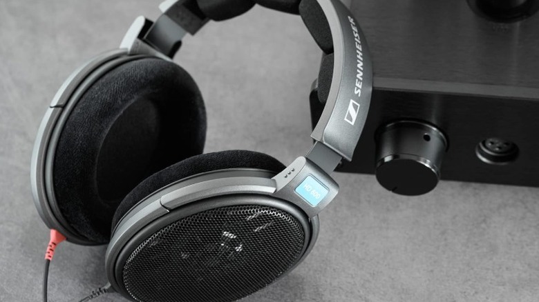 Sennheiser HD600 headphones resting on a headphone amp