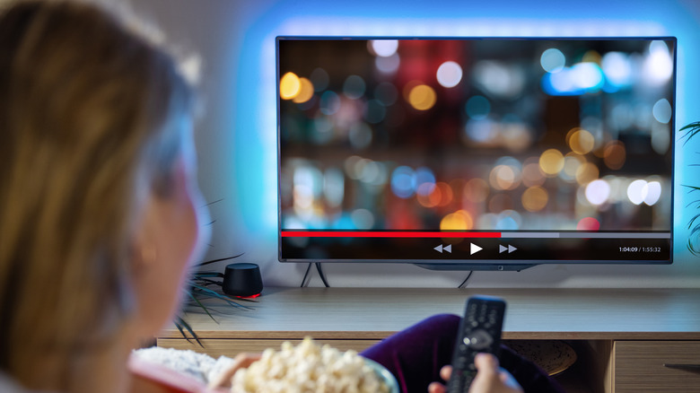 woman rewinding tv show