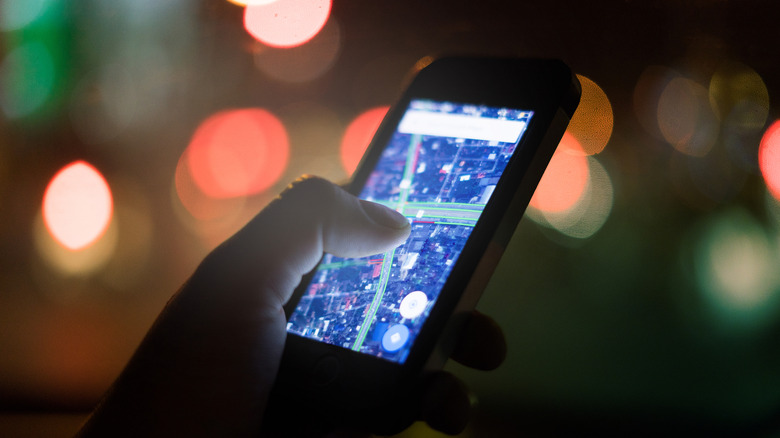Checking directions in navigation app on a mobile phone.