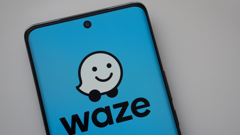 Waze app logo on a mobile phone.