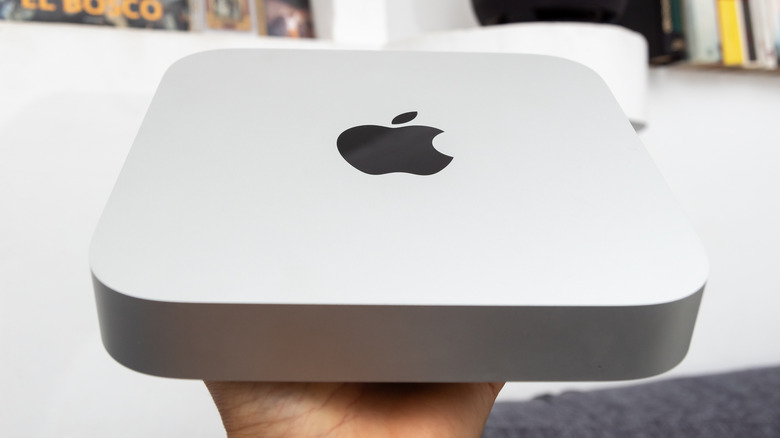 Person holding a Mac mini
