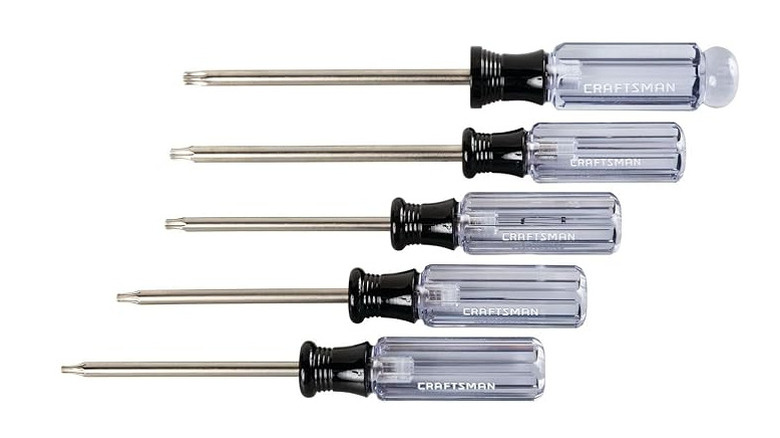 Transparent and black screwdrivers of various sizes on a white background