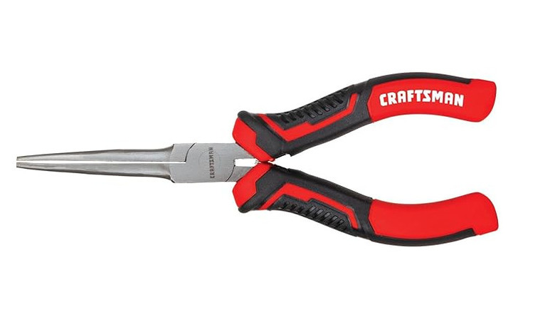 A red and black handled needle nose pliers with a white background