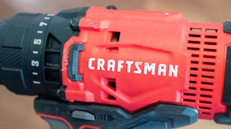 A white Craftsman logo on a red and black drill facing sideways