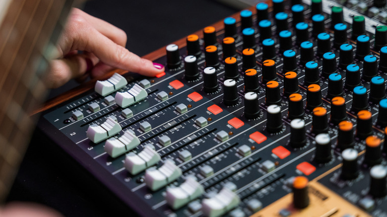 A person arms recording on a channel on the Tascam Model 12.