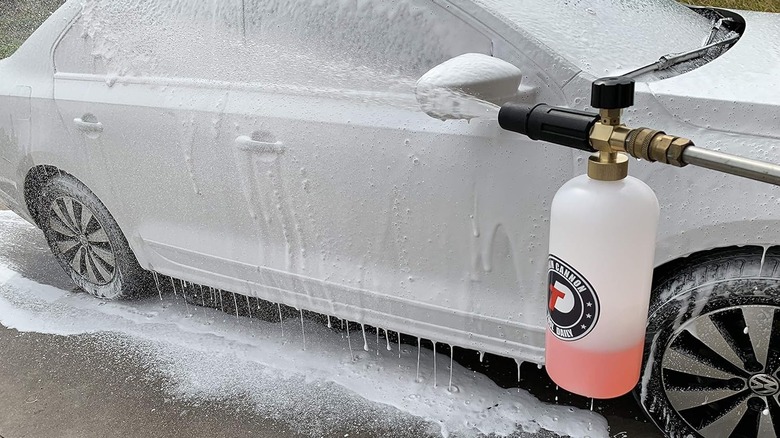 Someone washing their silver sedan with a Tool Daily Foam Cannon