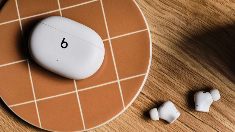 A Beats Studio Buds+ earbuds on top of a table