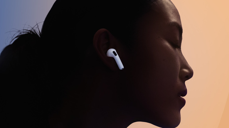 A woman wearing the Apple AirPods 5