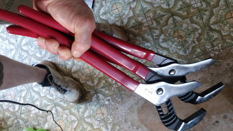 Close-up photo of Doyle groove joint pliers in man's hand