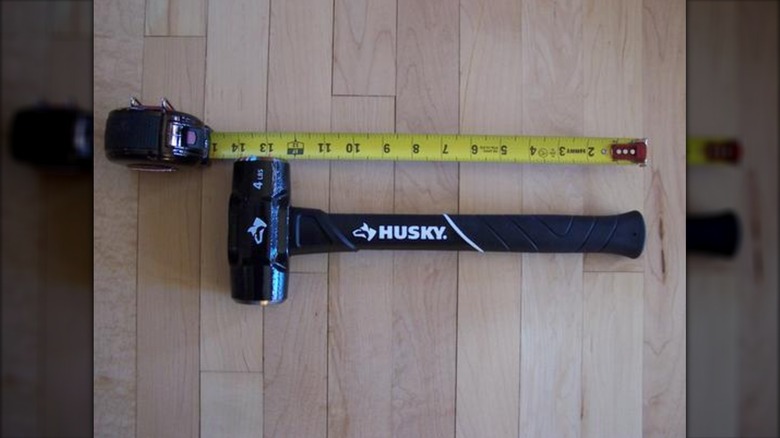 Close up of Husky hammer beside measuring tape