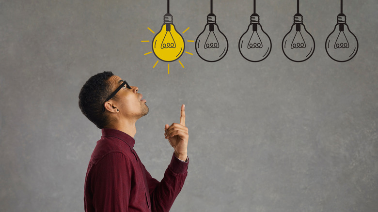 Person pointing to an animated light bulb